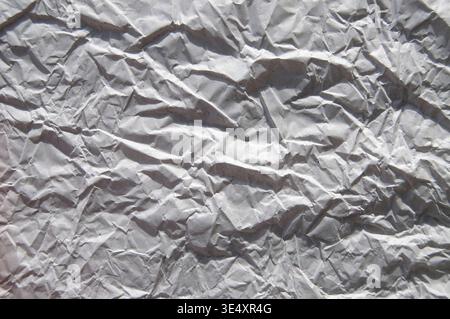 Crumpled gray paper texture. White wrinkled paper background. Stock Photo