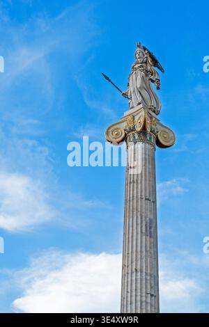 A marble statue of Athens on an Ionic column against a blue sky Stock Photo