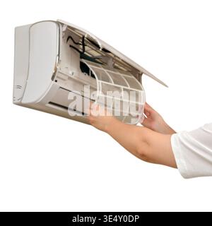 Woman repairing air conditioner. Female technician removing filter from wall split system unit. Domestic household maintenance, cleaning service and a Stock Photo