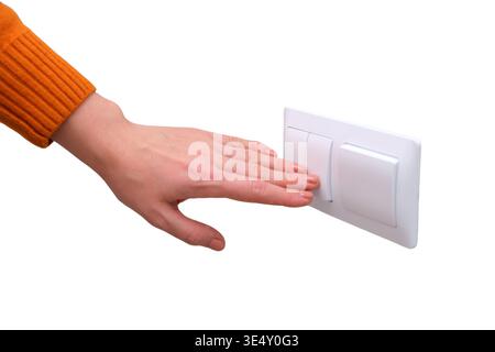 Woman hand turning on light switch on white wall. Human finger pressing electrical button to activate energy or illumination. Modern home equipment, p Stock Photo