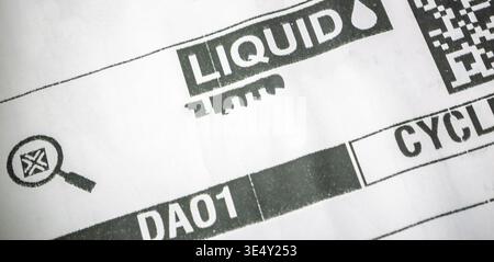 Close up of a delivery document showing LIQUID warning label and barcode, address in  printed on shipping paperwork Stock Photo