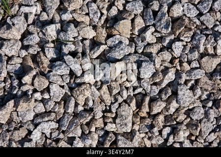 Top view of crushed granite stones and grey gravel texture on the ground Stock Photo