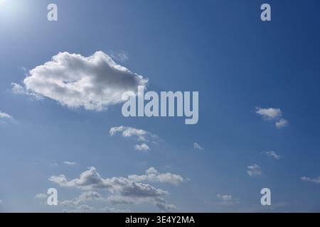 Large white cumulus cloud in a vibrant blue sky with copy space Stock Photo