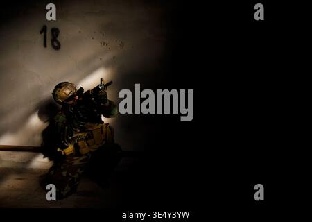 Special Forces Soldier Aiming Rifle in Dark Abandoned Building Stock Photo