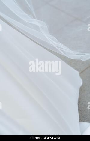Soft wedding veil and dress fabric detail in motion. Minimal and elegant bridal texture, light and airy aesthetic. Perfect for fashion and wedding Stock Photo