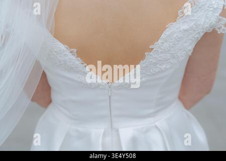 Wedding dress detail of buttons and lace on the back of a wedding dress  with the bride in the dress on her wedding day,close up photo of dress only  Stock Photo -