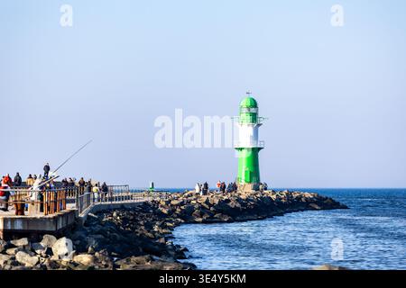 Green lighthouse on the seacoast in Warnemuende, Germany Stock Photo