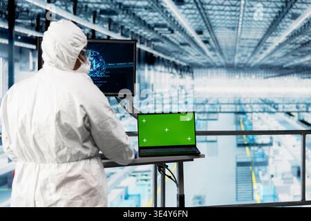 Green screen tablet, optimizing microchips and engineer man using AI. Monitoring semiconductor manufacturing plant systems, chroma key device close up and technician using deep learning Stock Photo