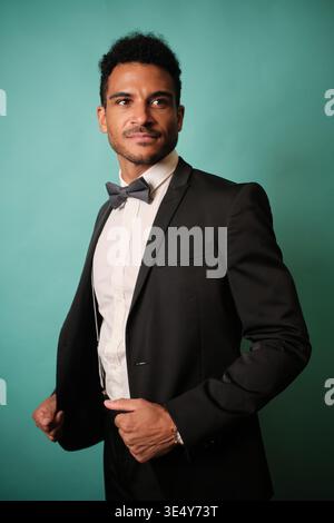 Confident man in a formal suit posing happily Stock Photo