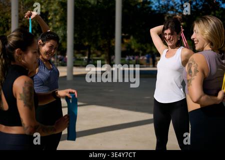 Women exercising together using resistance bands in park Stock Photo