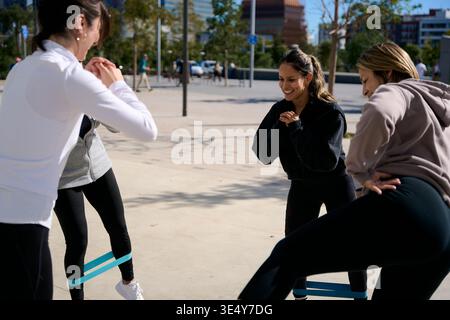 Women exercising with resistance bands outdoors Stock Photo