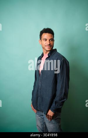 Confident man posing in denim shirt looking away Stock Photo