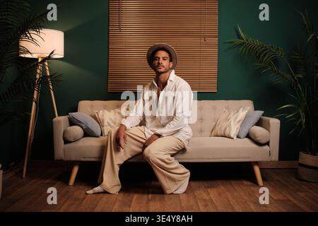 Man relaxing on sofa in stylish home interior Stock Photo