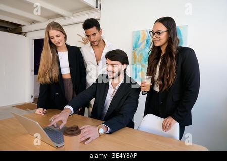 Diverse business team collaborating and discussing strategy Stock Photo
