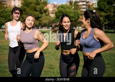 Group of women enjoying outdoor run in park Stock Photo