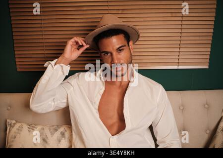 Confident man in fedora posing looking at camera Stock Photo