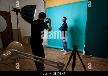 Photographer shooting male model in a studio Stock Photo