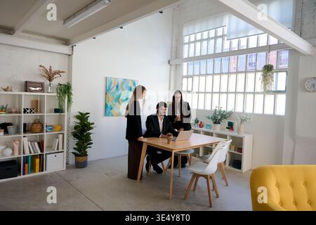 Business professionals collaborating on startup project in modern office Stock Photo