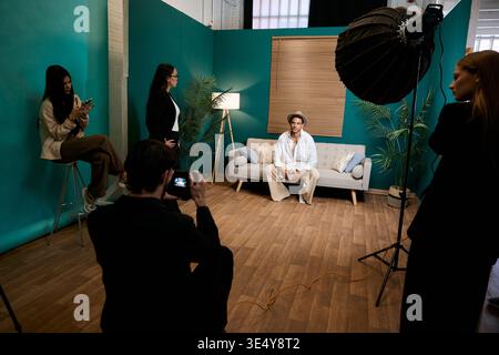 Fashion model posing during studio photo shoot Stock Photo