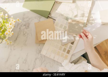 Interior designer choosing neutral fabric swatches Stock Photo