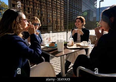 Business women enjoying outdoor coffee break together Stock Photo