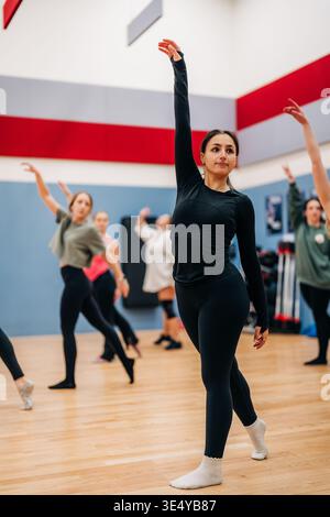Female dancers rehearsing ballet movement in studio class Stock Photo