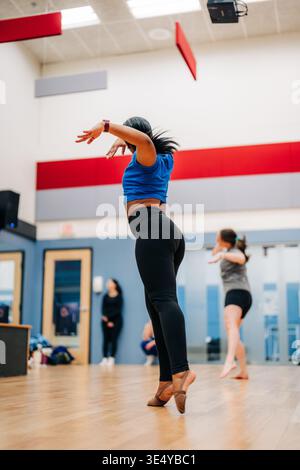 Dancer rehearsing challenging movement in a dance studio Stock Photo