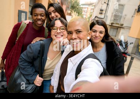 Group of diverse women smiling taking a selfie Stock Photo