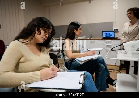 Students learning in a modern university classroom setting Stock Photo
