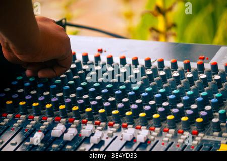 Professional audio engineer adjusting analog mixing console Stock Photo