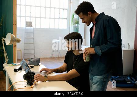 Creative men collaborating on computer in office Stock Photo