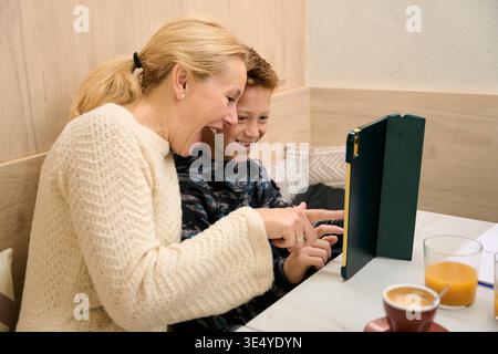 Mother and son laughing using digital tablet Stock Photo