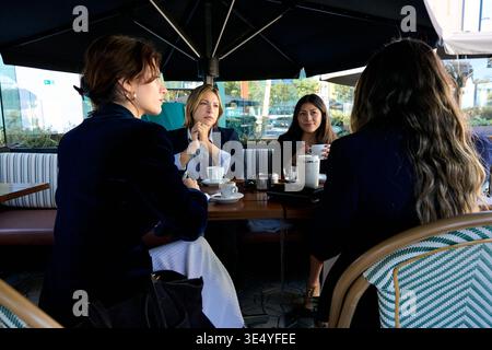 Women networking having coffee and business conversation outdoors Stock Photo