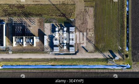 Aerial view of geometric structures casting stark shadows on the flat landscape, juxtaposed with agricultural fields, Zeewolde, Flevoland, Netherlands Stock Photo