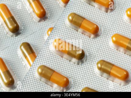 Close-up on blister of medical pills.  Background of medicine  pills. Set of yellow tablets pill in blister packaging. Stock Photo
