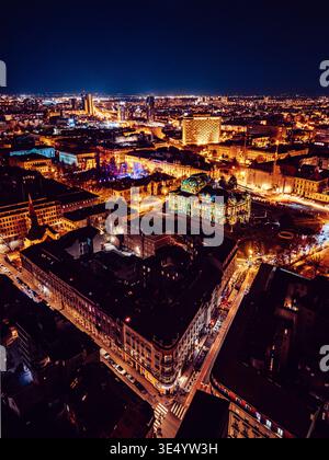 Aerial view of the night city glowing with lights from an airplane ...