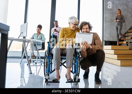 Multiracial coworkers analyzing charts and working together showing teamwork diversity and inclusion Stock Photo