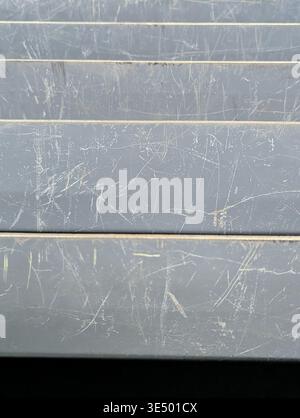 Macro Scratched Gray Metal Slats, Worn Surface With Fine Scratches, Scuffs, Paint Chips And Subtle Patina, Industrial Minimalism Background Ideal For Stock Photo