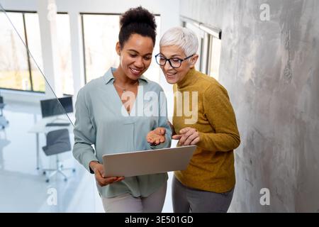 Mixed team of software engineers brainstorming ideas. Diverse app developers collaborating as group Stock Photo