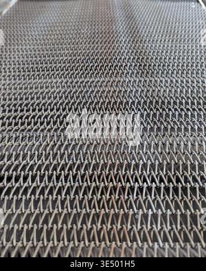 Tight Closeup Expanded Metal Mesh Pattern With Diamond Openings And Metallic Sheen, Shallow Depth Highlights Rhythm And Geometry, Modern Industrial Ba Stock Photo