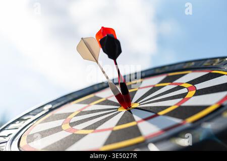Targeting board, red and white circles with arrows, darts target, marketing audience or bisiness stock on a blue sky background Stock Photo