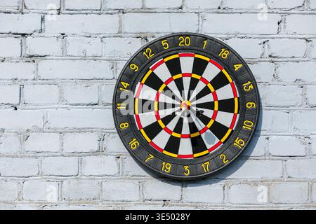 Target with three darts on a vintage brick wall. Successful hitting the target, marketing and advertising, concept Stock Photo