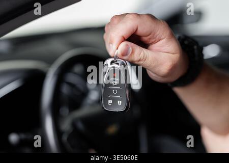 Male driver holding car keys, close-up. Rent a Car. Buying and selling Stock Photo