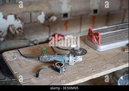 Construction tools on workbench with angle grinder – home renovation concept Stock Photo