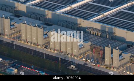 Aerial view of Datacenter Winschoten featuring industrial cooling towers, large roof structures, and solar panel arrays in Winschoten, Groningen, Neth Stock Photo