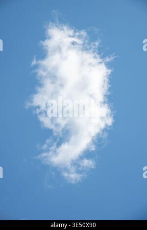 Bright blue sky filled with fluffy white clouds, varying in size and shape, creating a serene and tranquil scene. The clouds are well-defined against Stock Photo