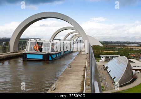 Falkirk Wheel rotating boat lift carrying a passenger boat across the Forth and Clyde Canal, a striking piece of engineering and modern landmark set a Stock Photo