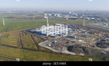 Groningen, Netherlands - 20 January 2026: Aerial view of Datacenter Westpoort with industrial infrastructure and green fields under a clear sky. Stock Photo