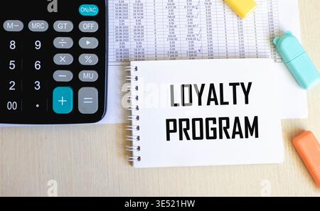 Loyalty Program text on a notepad on chart with keyboard and calculator. Stock Photo