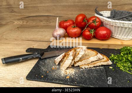 Creative collage composition featuring layered printed pages, a red tomato, white yarn, and textured fabric on a wooden table. The image blends everyd Stock Photo